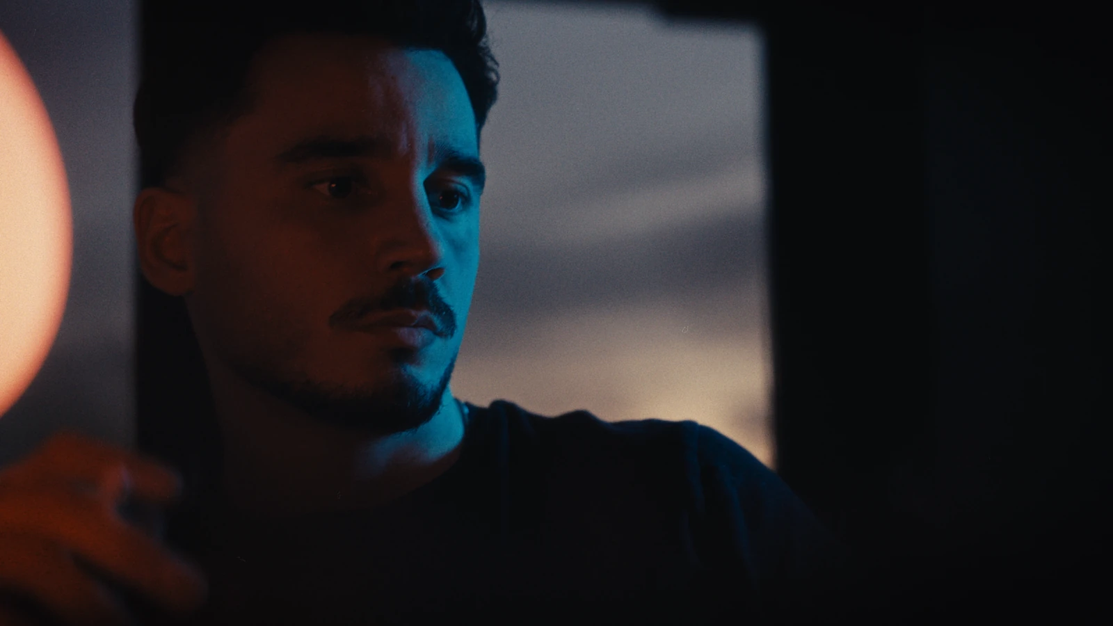 Sam Hox, founder of Second Eight, in the studio by a warm lamp